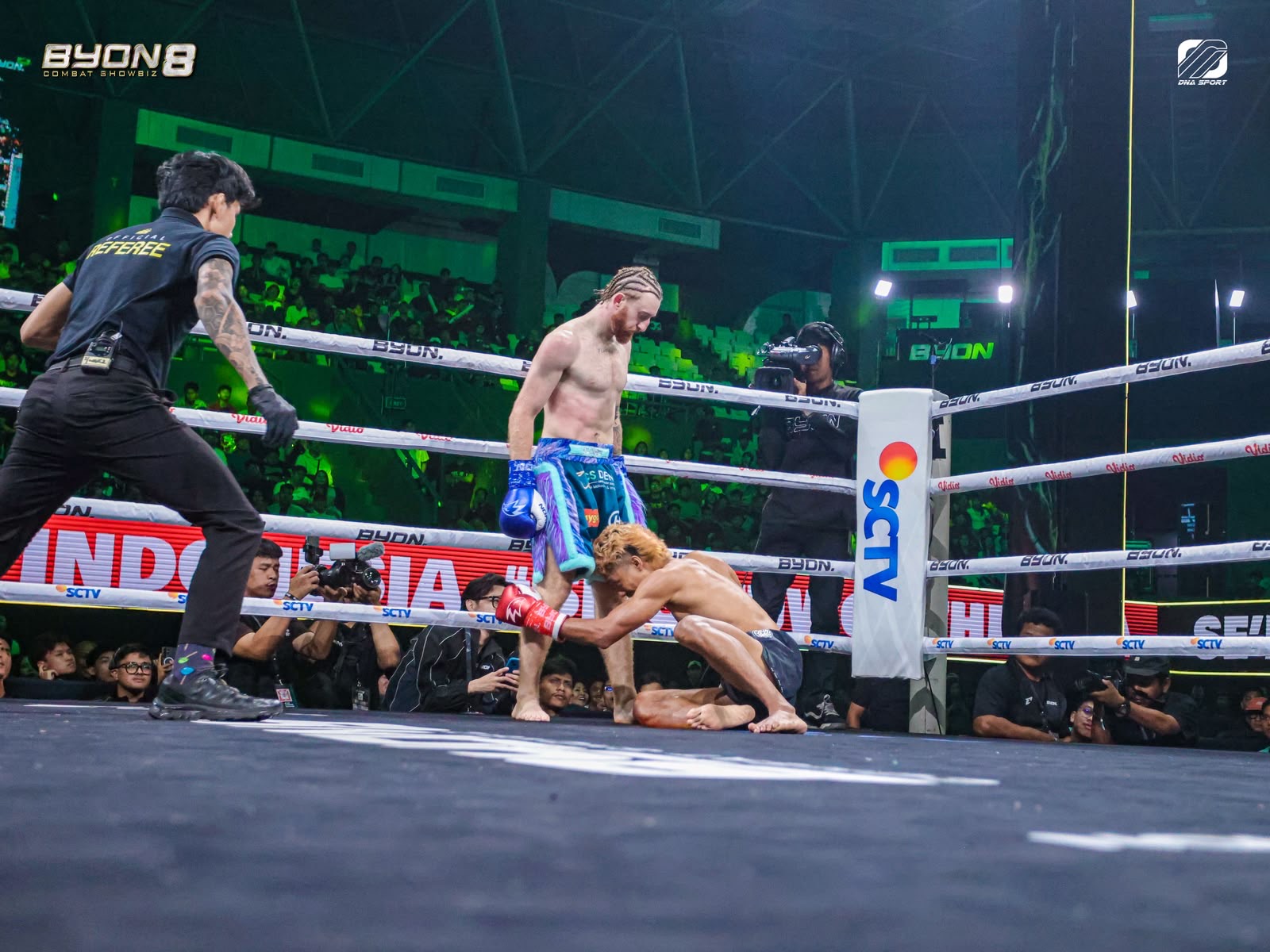 Aaron Clarke stands over Umarusman after stopping him at Byon Combat Showbiz 8